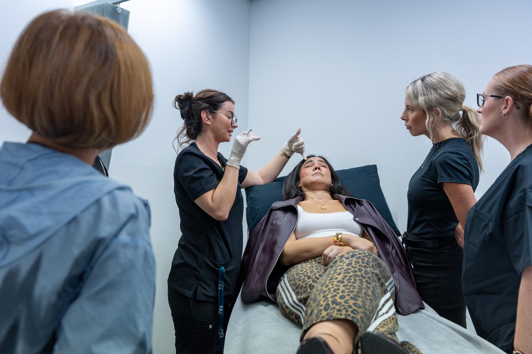 Faculty mentor guiding trainees through a live case