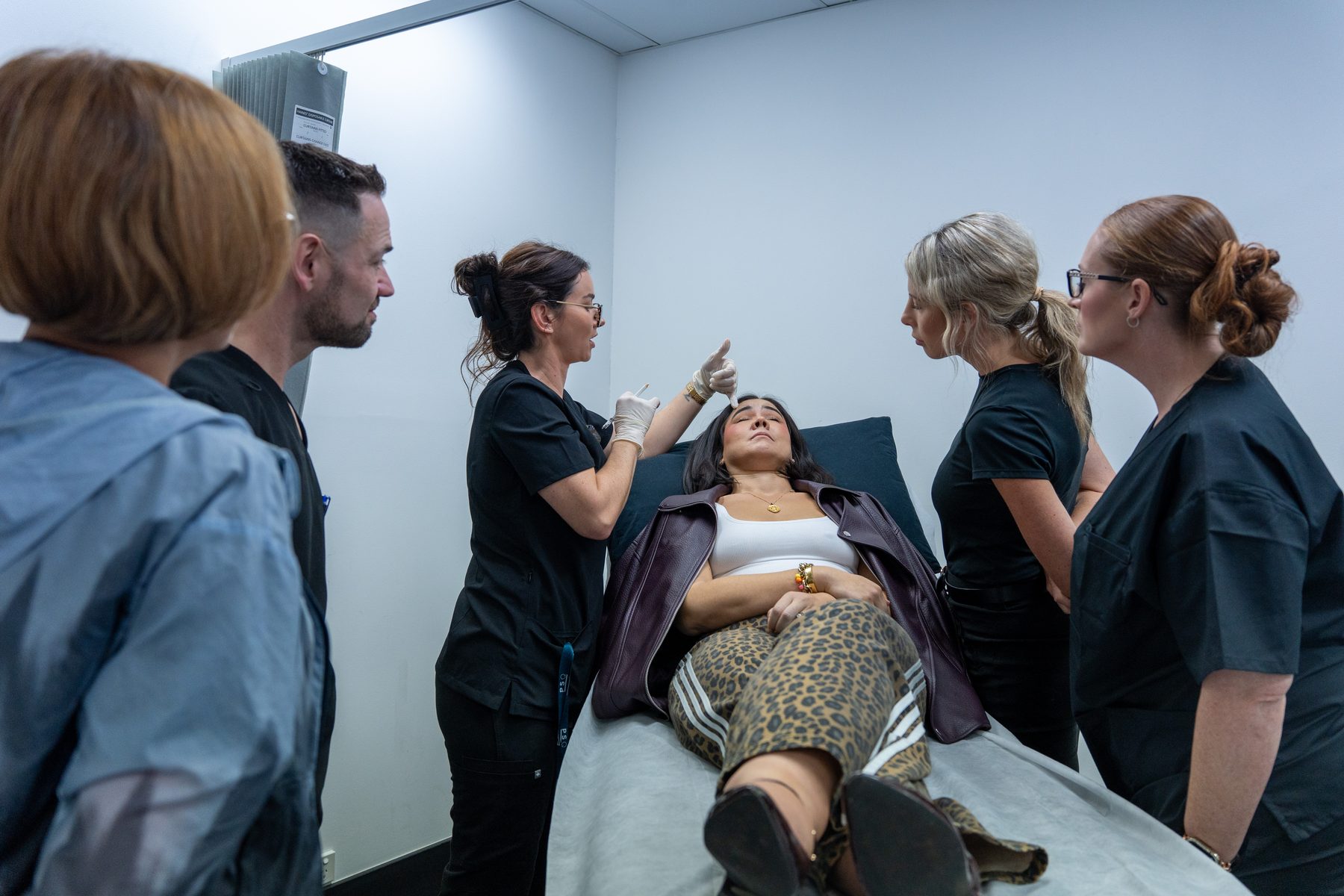 Trainer demonstrating an injection technique to a small group